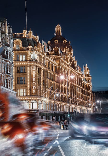 The ornate facade of a historic building in Knightsbridge decorated with festive holiday lights, star-shaped ornaments, and large decorative bunting for a Christmas event. The building features detail